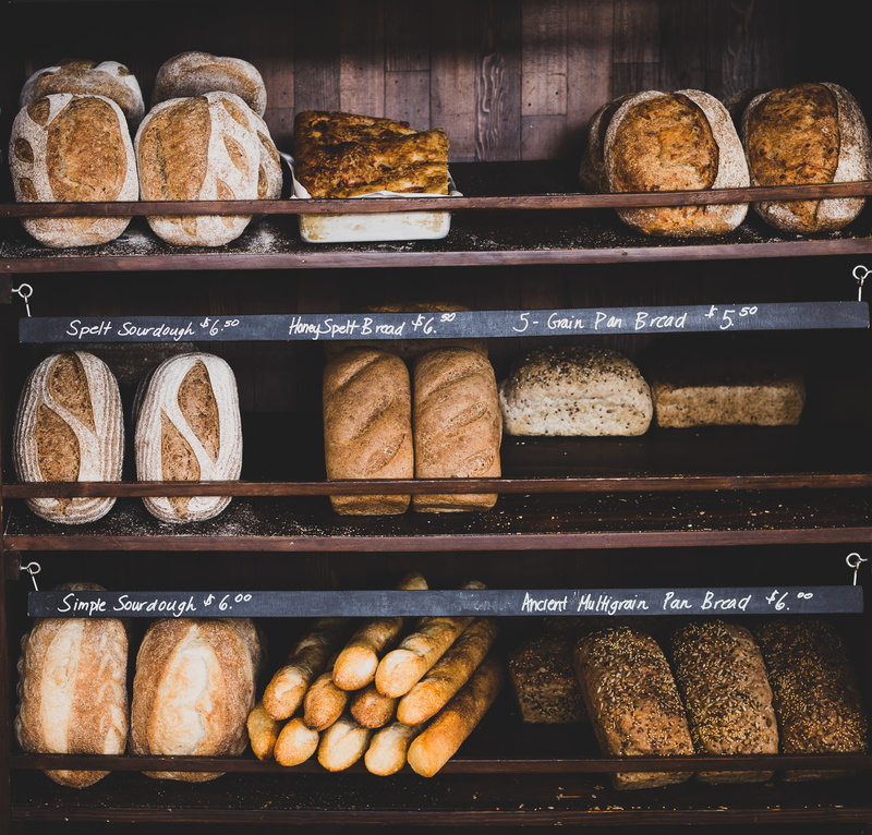 french food, variation, brown, arrangement, loaf of bread, tray, shelf, fabric, large group of objects, shop, bread, toast, food and drink, food, retail display