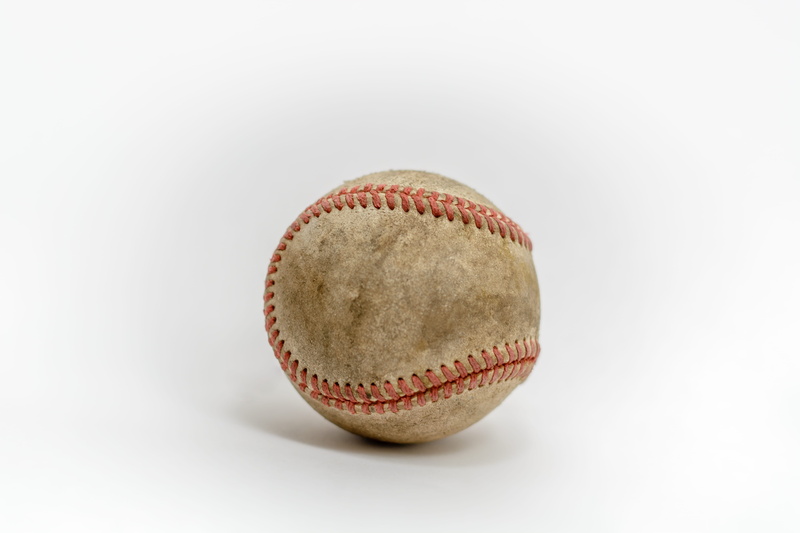 sport, apparel, simplicity, ball, still life, two objects, accessories, softball, snack, past time, cut out, team sport, baseball, diamond, clothing, face