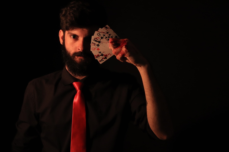 face, bad, tie, beard, front view, red, magician, young men, business person, indoors, letters, blood, magic, human face, 5K, dark, black background, men