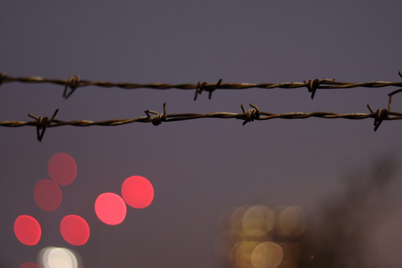 bulbs, low angle view, barb, security, boundary, clear sky, no people, blurred, illuminated, outdoors, glimpse, london, protection, barbed wire, night