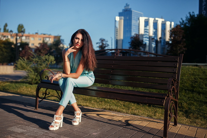 beauty, bench, focus on foreground, heels, women, brunette, real people, one person, lifestyles, outdoors, hairstyle, young adult, model, Kristina Romanova