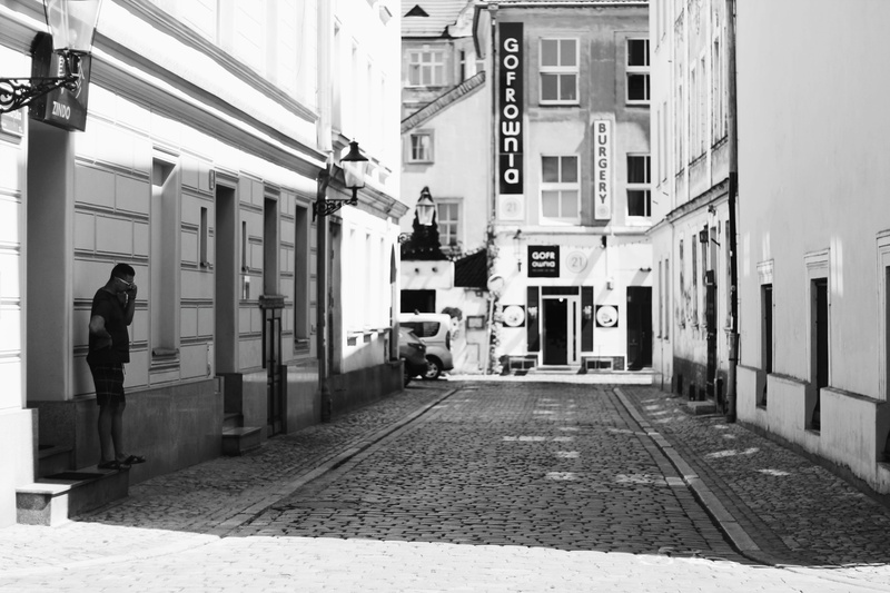 outdoors, real people, pavement, building exterior, building, monochrome, residential district, photography, man, lamppost, vehicle, direction, buildings