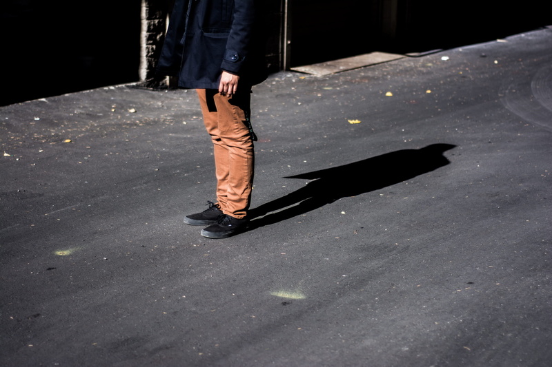 lifestyles, one Person, body part, city, photography, daytime, standing, human body part, human foot, black coat, person, sunlight, pants, women, shadow