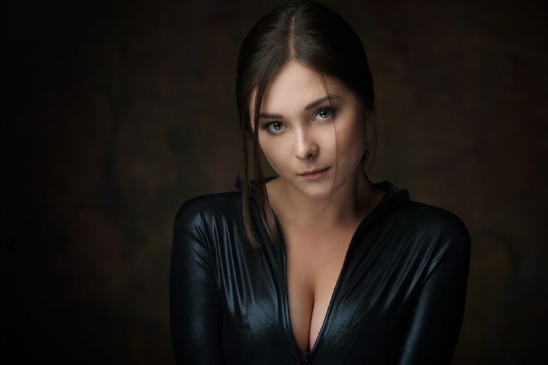 contemplation, young adult, hair, headshot, portrait, green eyes, black background, hairstyle, confidence, black clothing, cleavage, model, studio shot
