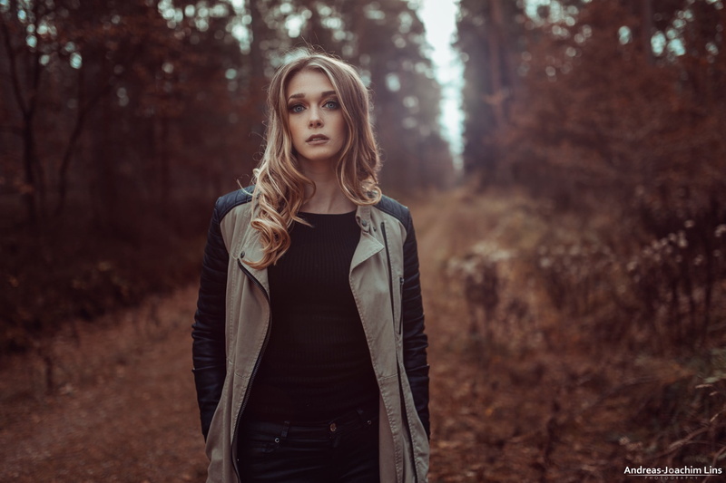 long hair, beauty, land, tree, front view, leather, blonde, hairstyle, forest, beautiful woman, black sweater, lifestyles, Andreas-Joachim Lins, portrait