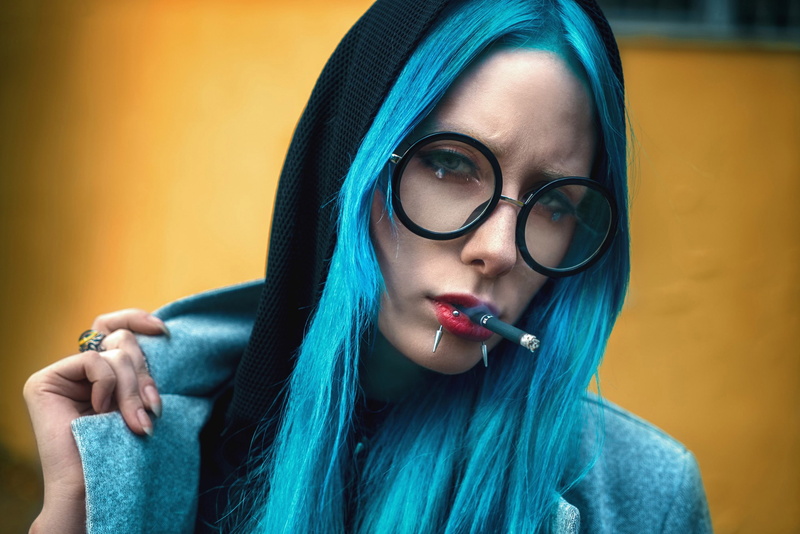 front view, indoors, studio shot, hoods, portrait, adult, lifestyles, one person, smoke, looking at camera, close-up, women, cigarettes, young women, dyed hair