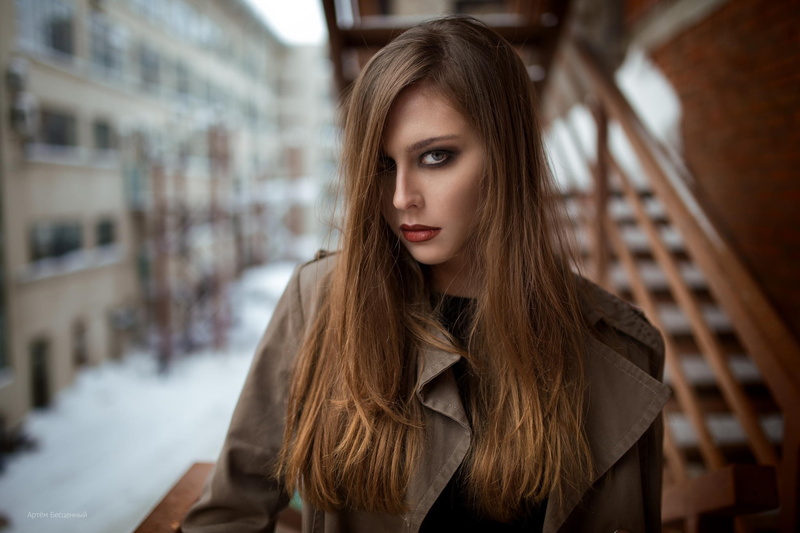 blue eyes, hairstyle, trench coat, grey coat, young adult, hair, long hair, model, teenager, front view, headshot, indoors, casual clothing, brown hair