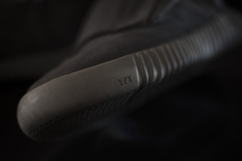 accessories, blade, dark, focus on foreground, textile, weaponry, selective focus, YEEZY, hose, adidas Yeezy Boost 750 OG, indoors, technology, close-up