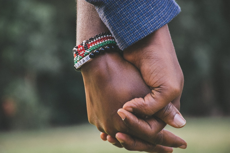 depth of field, real people, close-up view, precious moment, day, holding, women, blur, people, quality time, romantic, person, adult, couple, holding hands