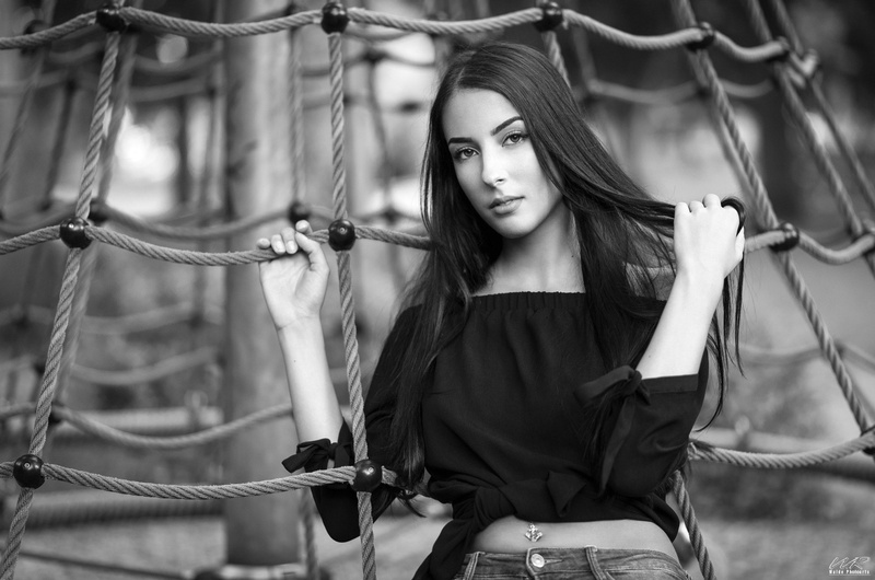 depth of field, young adult, pierced navel, monochrome, long hair, beautiful woman, 1080P, lifestyles, beautiful people, adult, hairstyle, focus on foreground