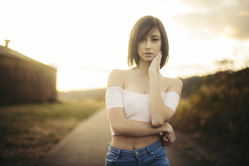 standing, young adult, lifestyles, sunlight, women outdoors, real people, portrait, lens flare, casual clothing, sunset, beautiful woman, young women, beauty