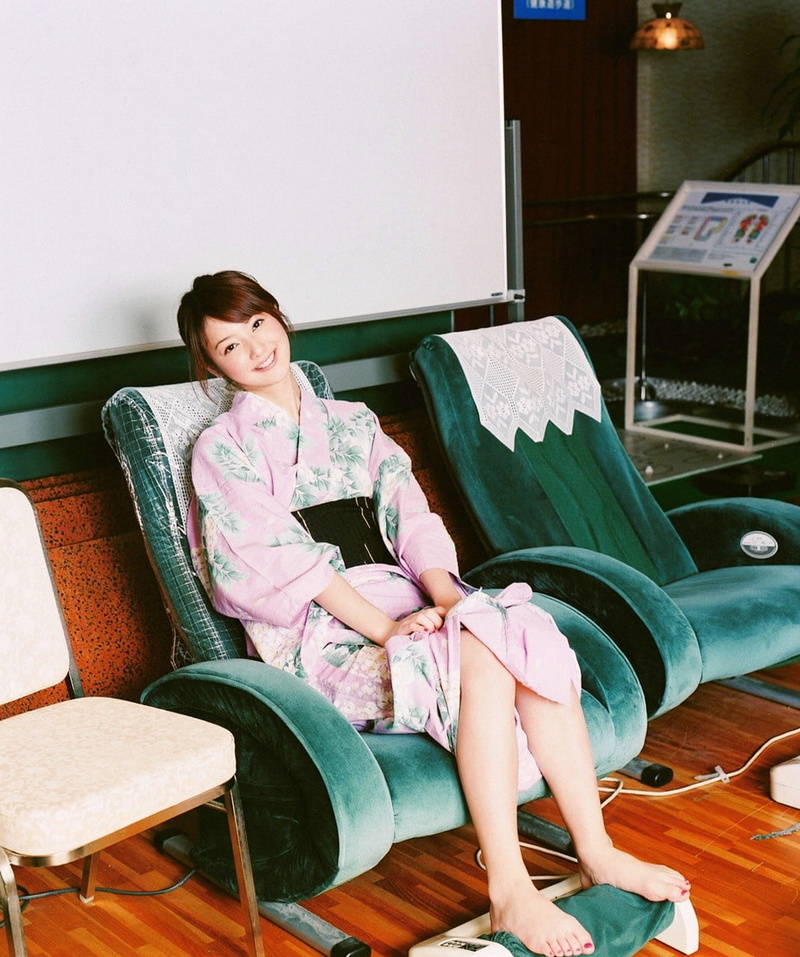looking at camera, Asian, indoors, adult, seat, full length, front view, casual clothing, sofa, relaxation, sitting, living room, chair, brown hair, armchair