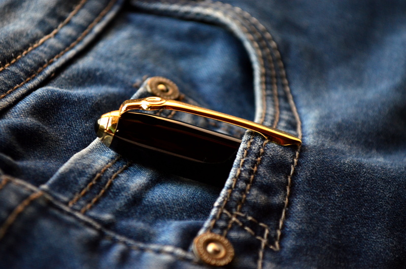 no people, selective focus, pen, gold, 4K, apparel, zipper, blue, close-up, washed, material, pocket, luxury, pants, wear, indoors, design, studio shot