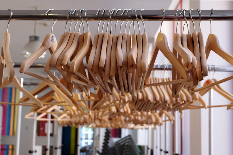 indoors, hangers on, hangers, close-up, wood - material, large group of objects, coat hangers, clothes rack, choice, clothes rail, no people, hanging rail