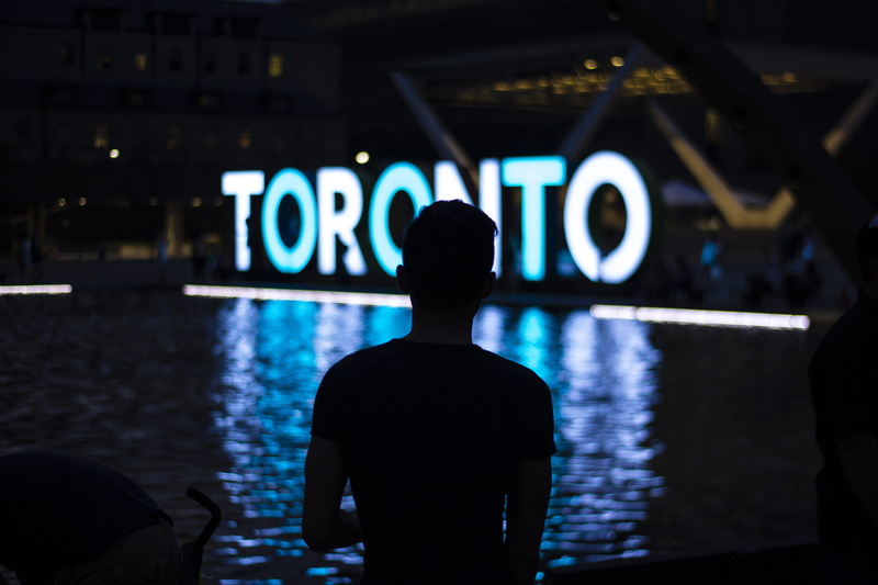 fountain, text, night, standing, sign, illuminated, architecture, real people, neon, man, western script, indoors, 5K, water, nighttime, led, freestanding