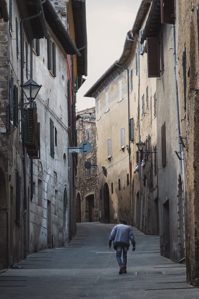 architecture, city, leisure activity, one person, italy, daytime, shoe, walking, building, real people, human, building exterior, home decor, sidewalk