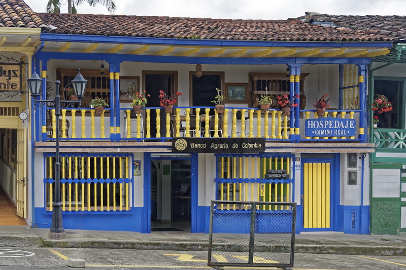 facade, colonial style, yellow, no people, text, entrance, built structure, colombia, communication, day, western script, outdoors, business, architecture