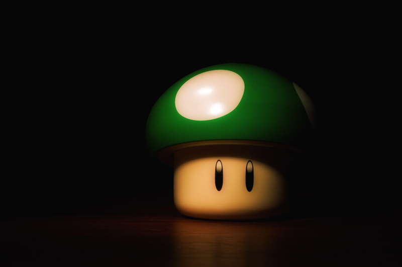 lighting equipment, cut out, warning sign, time, green color, close-up, indoors, clock, reflection, black background, ball, business, super mario mushroom
