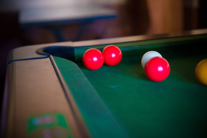 pool table, bar, snooker, sphere, no people, multi colored, pool hall, ball, table, billiards, bowls, yellow, selective focus, play, leisure games, arts culture and entertainment