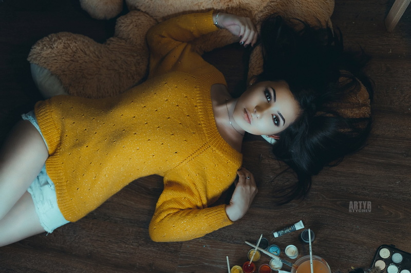 jean shorts, lying down, lying on back, indoors, wooden surface, beautiful woman, on the floor, portrait, adult, flooring, real people, artyr stychev, yellow sweater