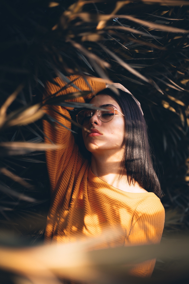 5K, face, hands on head, pink lipstick, black hair, women, model, women with glasses, sweater, yellow sweater, short hair, piercing, closed eyes