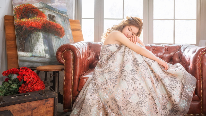 4K, she tilted her head, room, window, knees, sofa, bouquet, young, hem, suitcase, brown hair, dress, closed eyes, leather, style, long, light, painting
