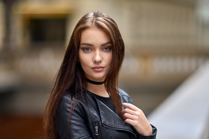 beautiful woman, one person, hairstyle, portrait, Milan R, long hair, 1080P, hair, looking at camera, casual clothing, brown hair, leather jacket, focus on foreground