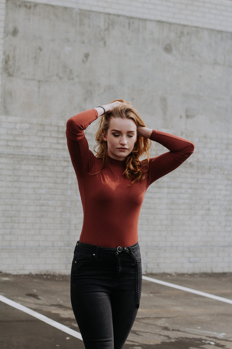 clothing, hand in hair, redhead, lifestyles, leisure activity, front view, standing, one person, near, young adult, beautiful woman, focus on foreground