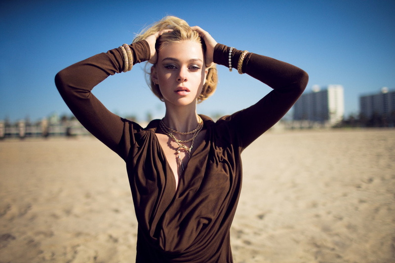 young adult, human arm, architecture, arms raised, looking at camera, Actress, young women, sky, standing, focus on foreground, beauty, sand, hairstyle