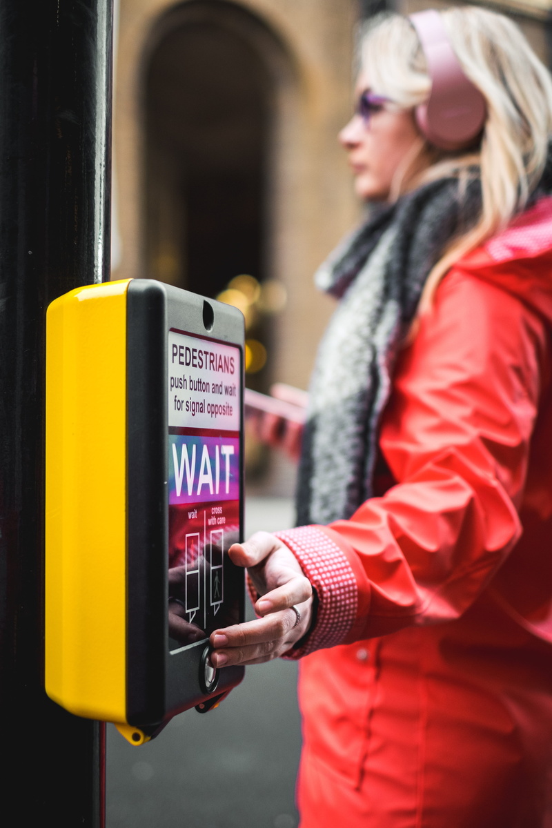 red jacket, tourism, technology, women, crossing, young Adult, button, uK, street photography, pedestrian crossing, sign, red coat, telephone, one Person