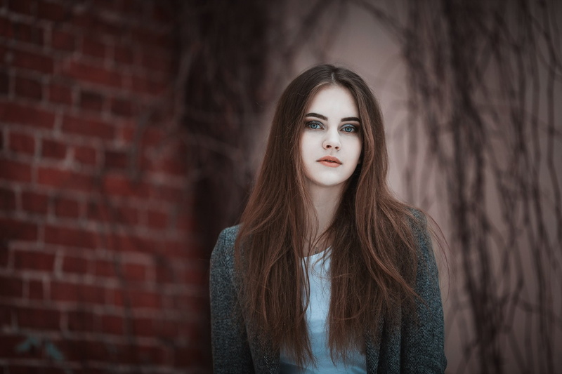 grey coat, front view, bricks, hairstyle, 1080P, adult, depth of field, young women, beautiful people, wall, blue eyes, hair, brick wall, women, one person