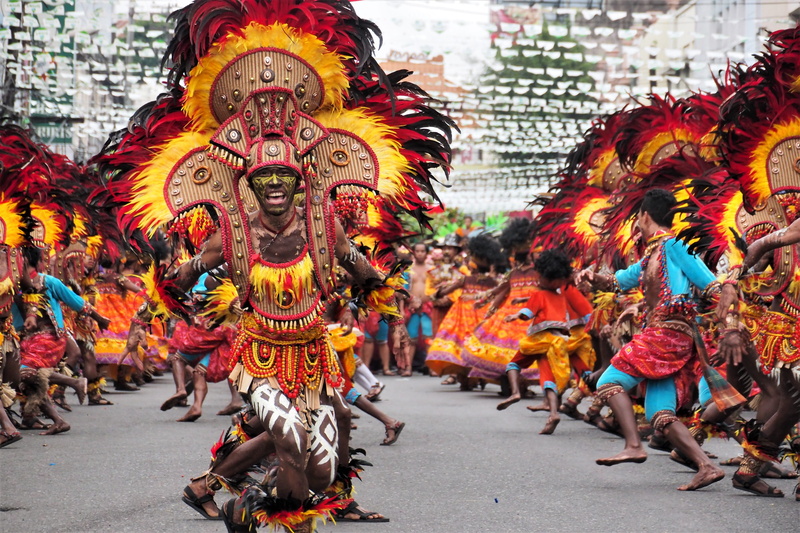road, art, native, traditional, religion, city, street, parade, group, built structure, dancing, tribal, costume, day, representation, multi colored, crowd