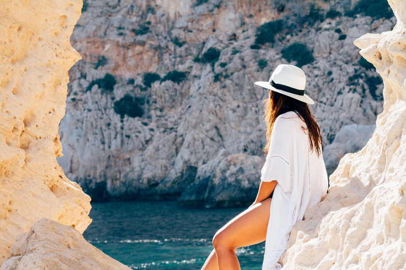 summer, hairstyle, adventure, back view, sitting, hair, relax, clothing, rock formations, ocean, relaxation, leisure, sun, people, rock, sand, water, sunbat