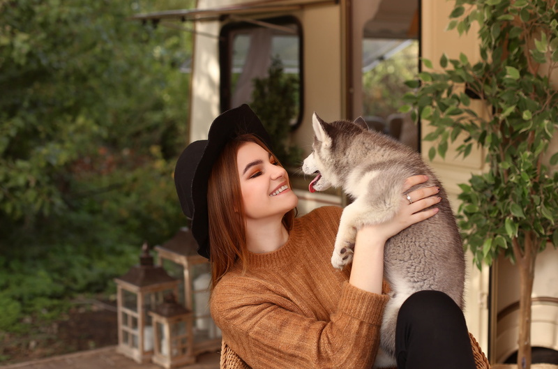 care, pet, positive emotion, young women, outdoors, pets, model, hairstyle, smiling, portrait, sweater, lifestyles, eyes closed, hat, cat, one animal, mammal