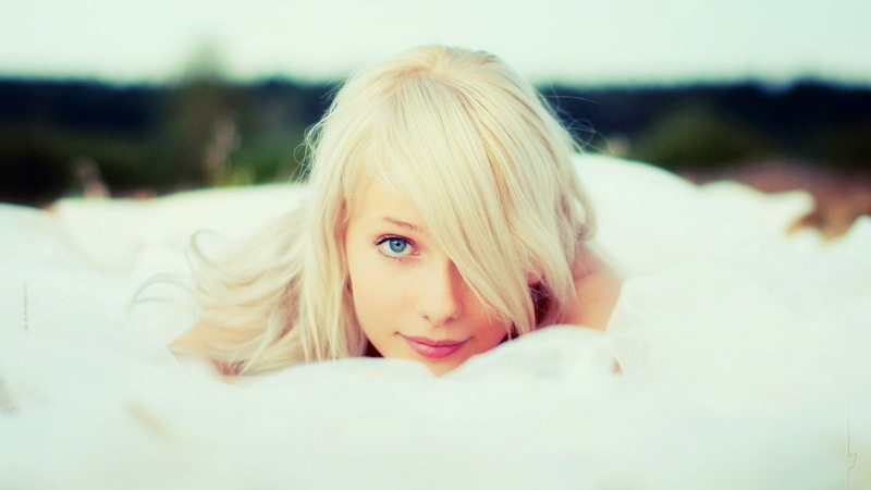 young adult, blond hair, close-up, looking at viewer, hairstyle, real people, adult, teenager, contemplation, young women, lying on front, lifestyles, one person