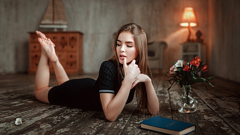 tiptoe, auburn hair, 1080P, legs up, dress, books, black dress, Vasilisa Sarovskaya, looking away, lying on front, long hair, lying down, Georgy Chernyadyev