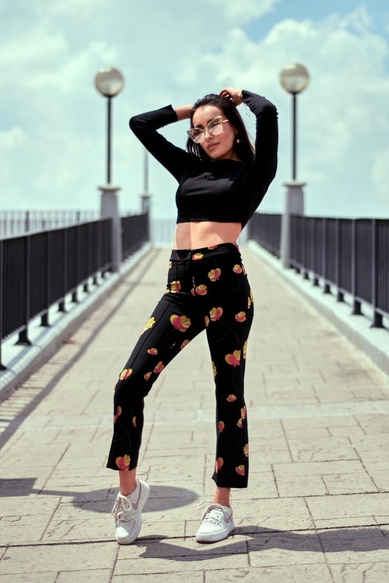 surface, outdoors, sky, tire, footpath, clothing, full length, human, beautiful woman, shoe, standing, front view, portrait, daytime, apparel, footwear