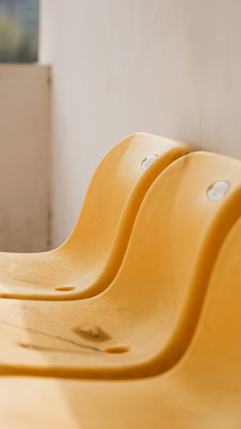 plastic, selective focus, plywood, yellow, armchair, indoors, wood - material, focus on foreground, couch, empty, day, lcd screen, seat, slide, display