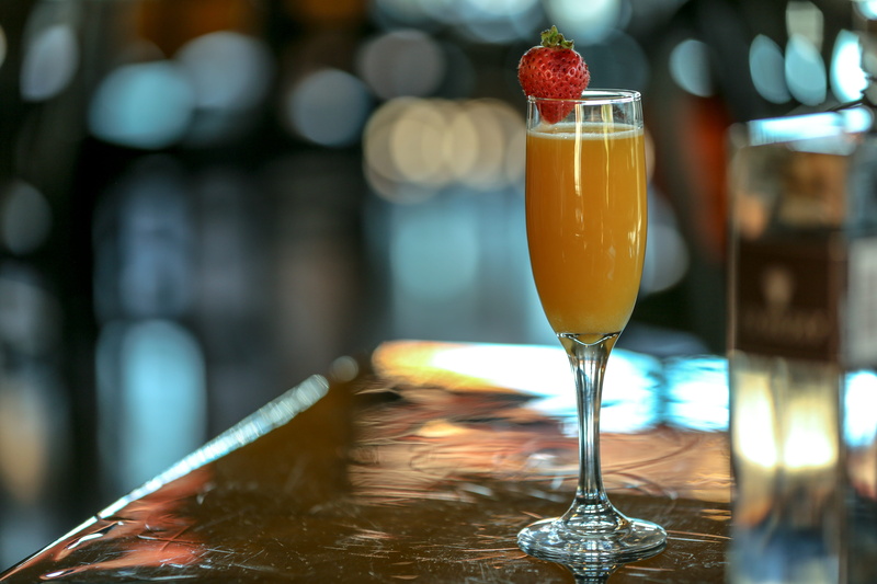 glass - material, bar, drink, cold, glass, beverage, indoors, strawberry, restaurant, wineglass, ready-to-eat, champagne glass, food and drink, juice, mimosa