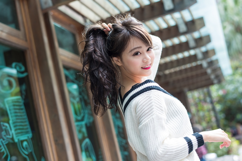 adult, hair, young adult, beauty, outdoors, casual clothing, sweater, holding hair, hairstyle, smiling, Asian, one person, waist up, looking at viewer
