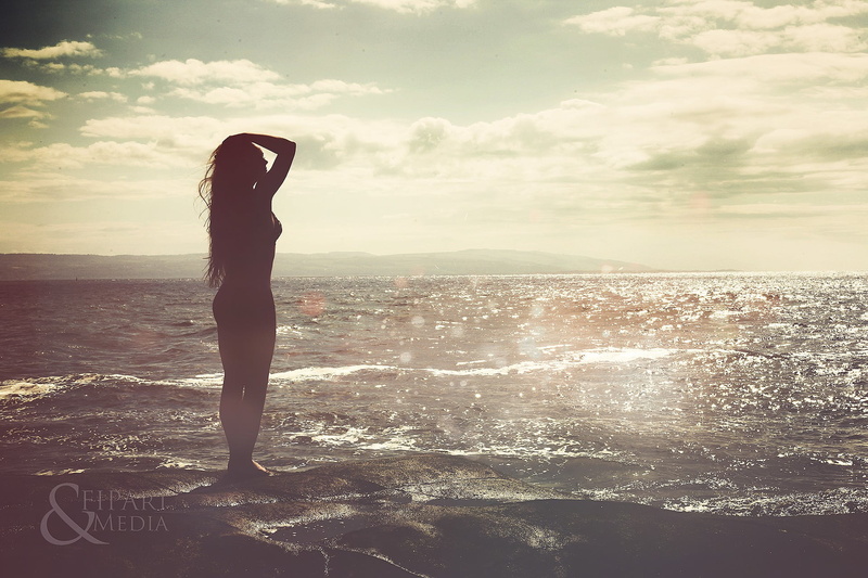 water, human arm, standing, outdoors, nature, leisure activity, one person, adult, lifestyles, land, horizon over water, beach, near, long hair, cloud - sky