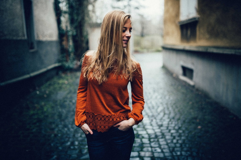 focus on foreground, real people, young women, street, casual clothing, standing, women outdoors, hairstyle, one person, long hair, hands in pockets, three quarter length