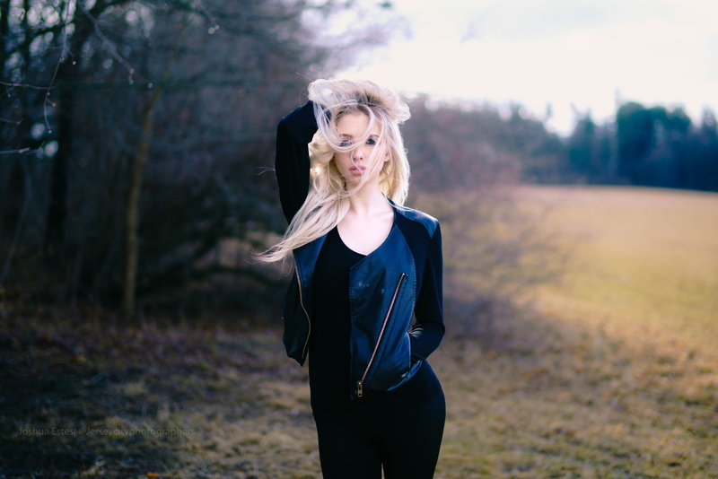 women outdoors, 1080P, hands in pockets, blonde, blue eyes, hair in face, leather jackets, hands in hair