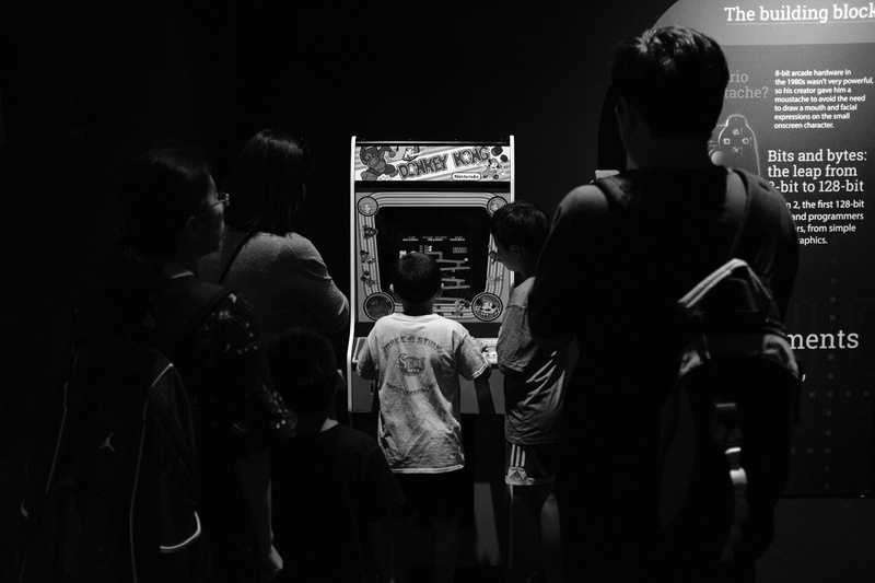 retro games, 500px, arts culture and entertainment, standing, rear view, technology, casual clothing, adult, monochrome, women, medium group of people