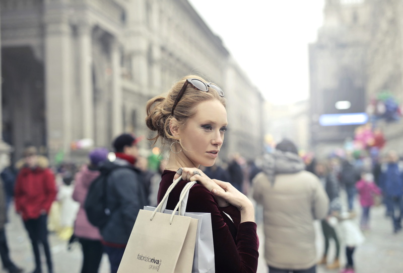 earring, focus on foreground, street, jewel, young adult, sale, beautiful woman, architecture, brown, shop, city street, hair, beauty, stock, maroon, battle
