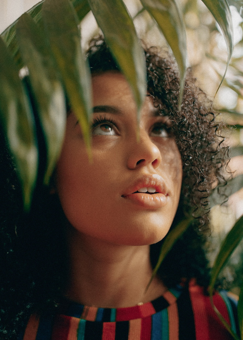 headshot, close-up, plant, 2K, young adult, hairstyle, ebony, front view, leaf, body part, nature, adult, curly hair, looking away, one person, contemplation