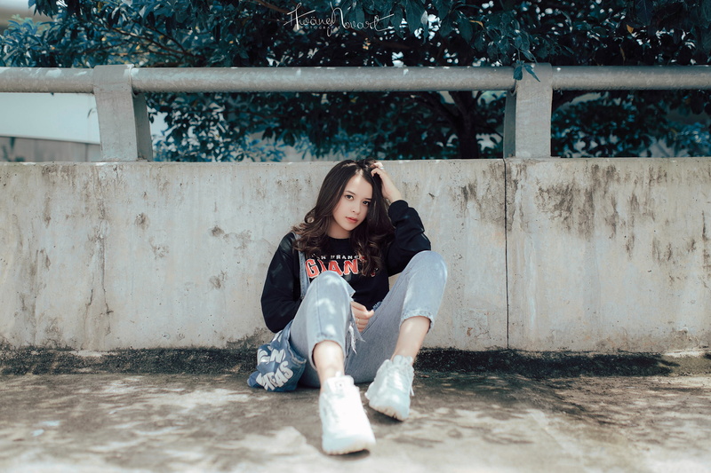 young women, casual clothing, Asian, lifestyles, brunette, full length, depression - sadness, jeans, social issues, sitting, front view, emotion, sneakers