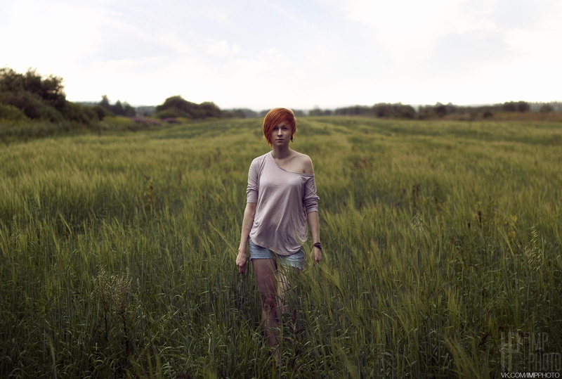 three quarter length, plant, environment, sky, growth, grass, looking at camera, redhead, shorts, nature, land, young adult, field, casual clothing, outdoors
