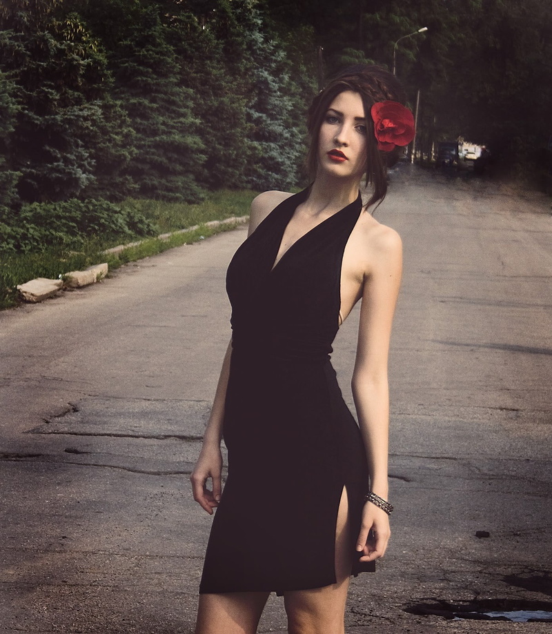 model, standing, one person, real people, beauty, looking at camera, flower in hair, s, 720P, red lipstick, black dress, beautiful woman, young adult
