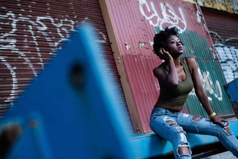 contemplation, built structure, real people, women, young women, s, wall - building feature, lifestyles, torn jeans, leisure activity, focus on background